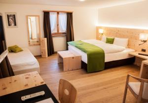 Postel nebo postele na pokoji v ubytování Wellnesshotel Liun