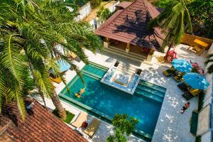 an overhead view of a swimming pool next to a house at Gila House - Adults only in Gili Islands