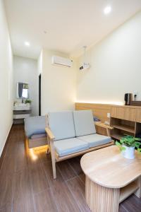 a living room with a couch and a table at Cái Vườn Ấm in Lái Thiêu