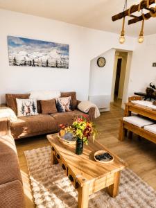 a living room with a couch and a coffee table at Le Terrier- Chaleureux avec Jardin privatif et parking pour 2 voitures in Briançon
