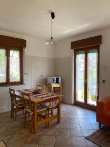 a kitchen with a table and chairs in a room at Casa Martello in Levico Terme