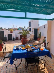 a blue table with plates of food on a patio at RIAD YOUSSEF in Fez