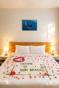 a bedroom with a bed with flowers on it at Sun Beach Dhigurah in Dhigurah
