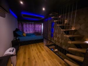 a room with a bed and a staircase in it at Suite romantique avec jaccuzzi - proche des lacs - La secrète room in La Mure +42 photos