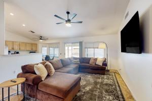 a living room with a couch and a ceiling fan at Suitewater in Peoria