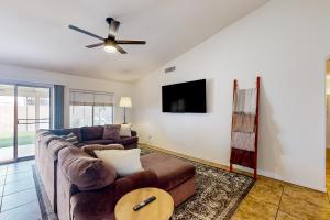 a living room with a couch and a ceiling fan at Suitewater in Peoria