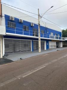 a blue building on the side of a street at Hotel Arara Azul in Barra do Garças