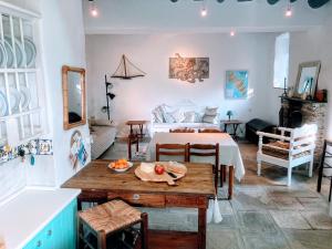 a living room with a bed and a table with fruit on it at The Priest House in Makrotándalon
