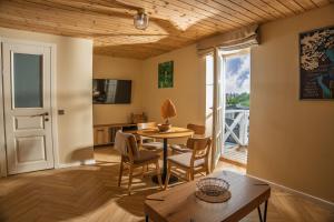 a living room with a table and chairs and a window at Prance namai in Plateliai