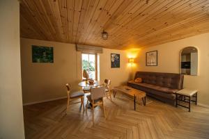 a living room with a couch and a table at Prance namai in Plateliai +43 photos