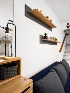 a living room with a blue couch and a shelf at Villa Pilgrimos in Ierissos +33 photos