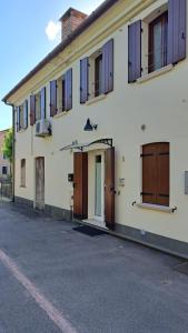 a building with doors and windows on a street at open space apt - comodo a Venezia in Treviso