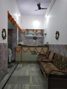 a living room with couches and a table in a room at Vandana Hotel in Dehri