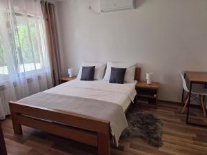a bedroom with a large bed and a window at House Bogović in Karlovac