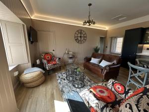 a living room with a couch and a table at Broombarns Farm Cottage in Forgandenny