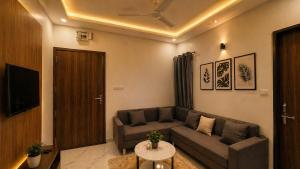 a living room with a couch and a table at Lado by Stay Junction in Indore