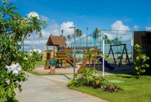 a park with a playground with a slide at Mana Beach Exclusive in Porto De Galinhas