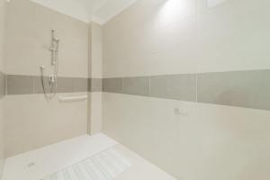 a white bathroom with a shower and a shower at Residence Padulella - Goelba in Portoferraio
