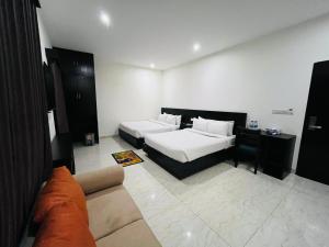 a hotel room with a bed and a couch at Marineview Hotel Kuakata in Kuākāta