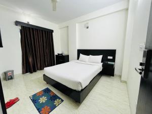 a bedroom with a white bed and a window at Marineview Hotel Kuakata in Kuākāta