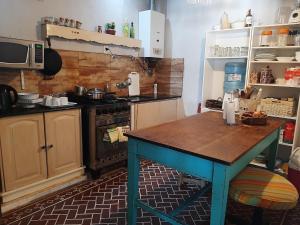 a kitchen with a table in the middle of it at Vecchia Casa en el centro in General Villegas