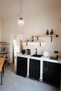 a kitchen with a sink and a counter top at EOS Small House in Pollonia