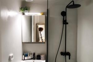 a bathroom with a mirror and a sink at EOS Small House in Pollonia +18 photos