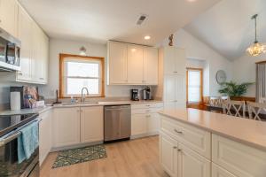 a kitchen with white cabinets and a sink at Seagrove View - NH MP 10.5, Oceanside, 800 ft to the BEACH, YMCA Passes in Nags Head