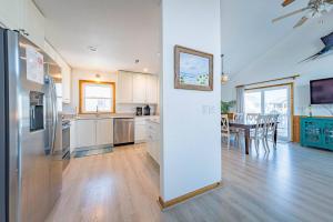 a kitchen with a refrigerator and a dining room at Seagrove View - NH MP 10.5, Oceanside, 800 ft to the BEACH, YMCA Passes in Nags Head +37 photos