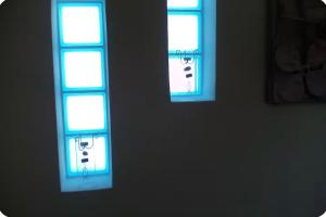 two windows in a room with blue lights at Terra Naxos in Galini