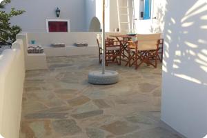 a patio with a table and chairs and a stone floor at Terra Naxos in Galini