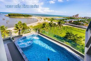 a swimming pool with a view of the beach at The Rebirth Apartment Binh Chau Ho Tram in Bà Rịa