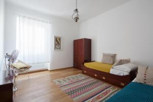 a bedroom with a bed and a window and a rug at Appartamento Vela Verde in Sestri Levante