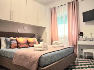 a bedroom with a bed with two towels on it at Roman sunset beach in Ladispoli +41 photos