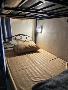 a bunk bed with a pillow on top of it at The Station Hostel in Sathani Ayutthaya