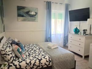 a small bedroom with a bed and a dresser at Roman sunset beach in Ladispoli