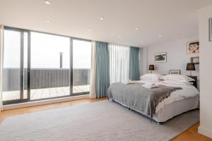 a bedroom with a large bed and large windows at 4 Bed in Hythe oc-p30519 in Hythe