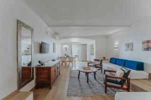 a living room with a couch and a table at Apartamentos Borda D´Agua in Albufeira
