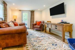 a living room with a couch and a tv at 4 Bed in Looe oc-p00795 in Lansallos