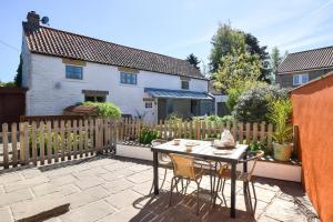 a patio with a table and chairs and a fence at 2 Bed in Scarborough oc-82543 in Snainton