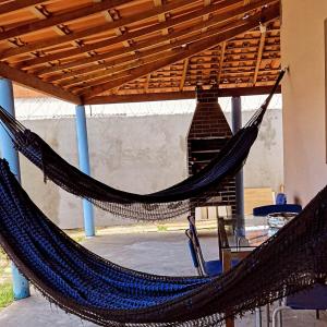 a pair of hammocks under a pergola at Casa do ViajanteBr in Barreirinhas