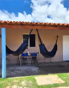 a patio with two hammocks on a house at Casa do ViajanteBr in Barreirinhas