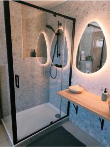 a bathroom with a shower with two circular mirrors at LA SUITE 159 in Namur +24 photos