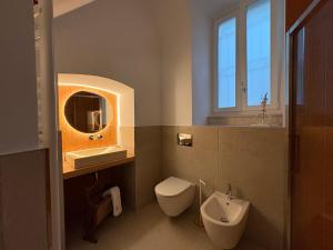 a bathroom with a toilet and a sink and a mirror at TerraCielo in Bisceglie
