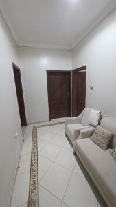 a white living room with a couch and a rug at مساكن جدة in Jeddah