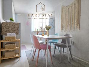 a dining room with a table and four chairs at 수원 행궁 Haru Stay in Suwon