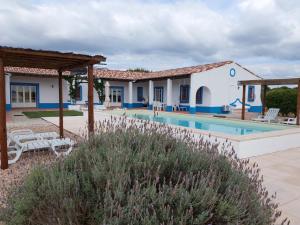 a villa with a swimming pool and a building at Monte do Sobreiro in Vimieiro