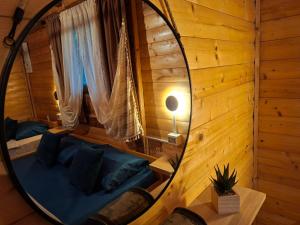 a mirror reflection of a bed in a room at Jack Sparrow's cottage- Ada Bojana River in Donji Štoj
