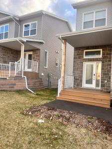 a house with a porch and a deck at Peace House in Bills Island