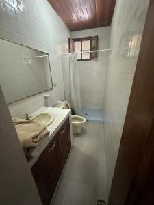 a bathroom with a sink and a toilet and a mirror at Full house, 2 Bedroom & kitchen in Bocas Town +11 photos